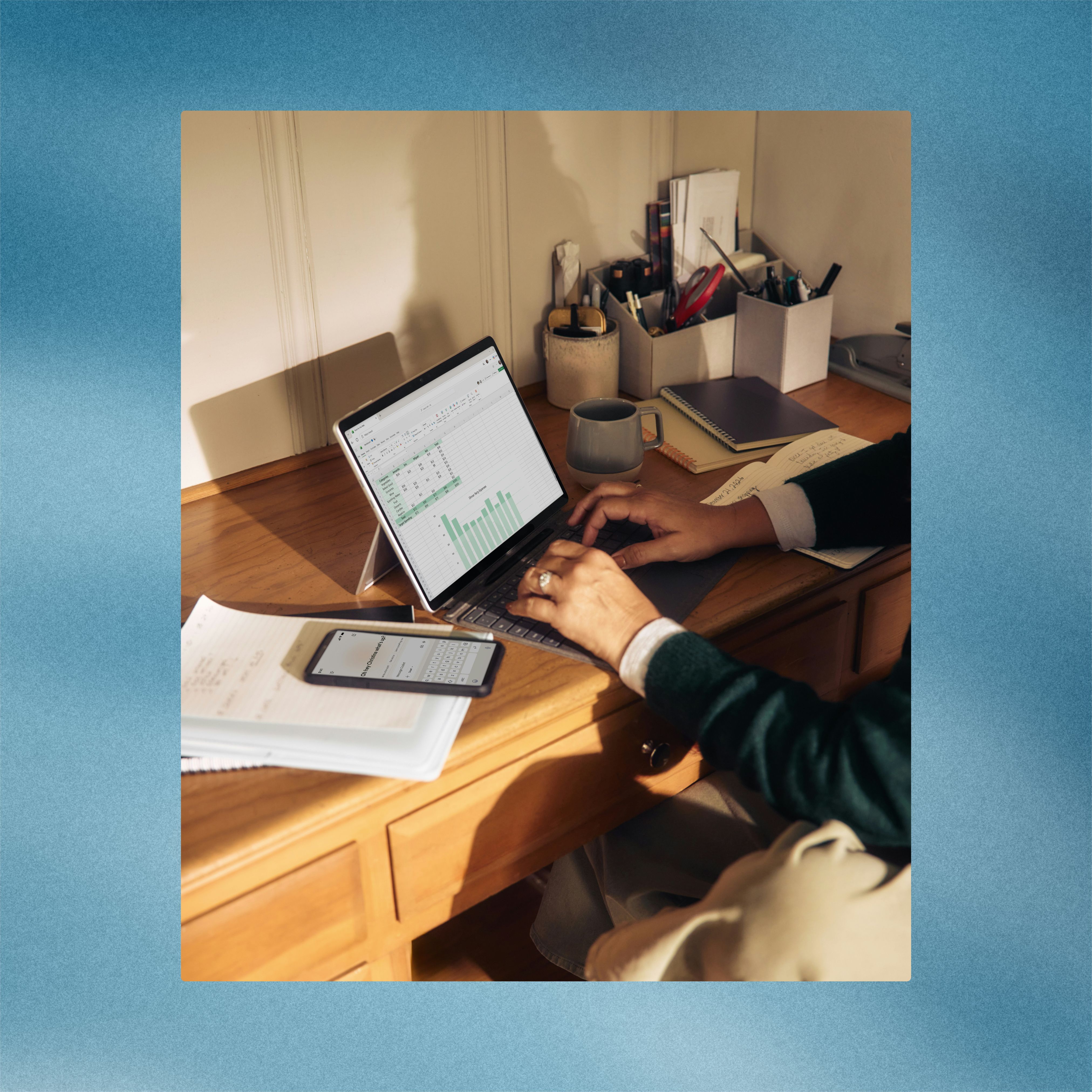 Person working on a spreadsheet on a laptop at a desk